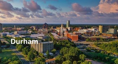 Skyline of Durham, NC, featuring modern buildings and green spaces under a picturesque sky